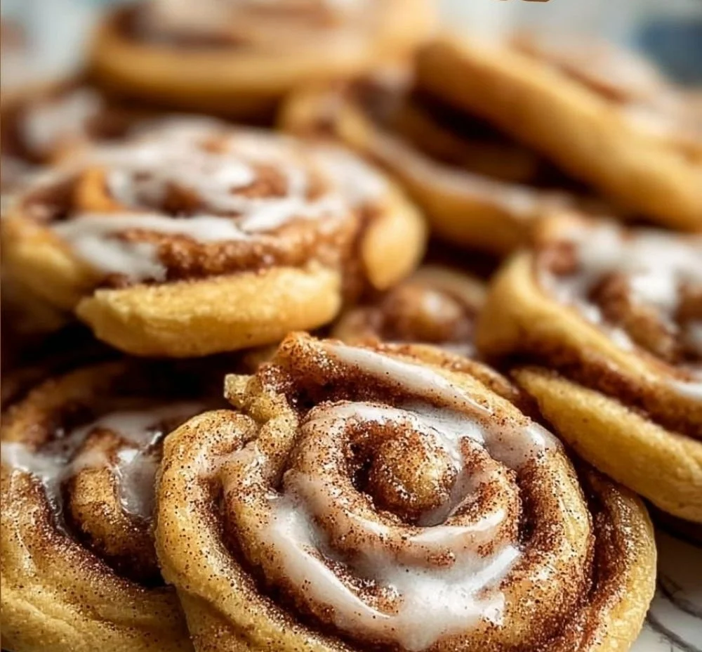 Freshly baked cinnamon roll cookies on a cooling rack