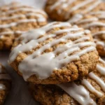 Iced oatmeal cookies with a creamy icing on a decorative plate