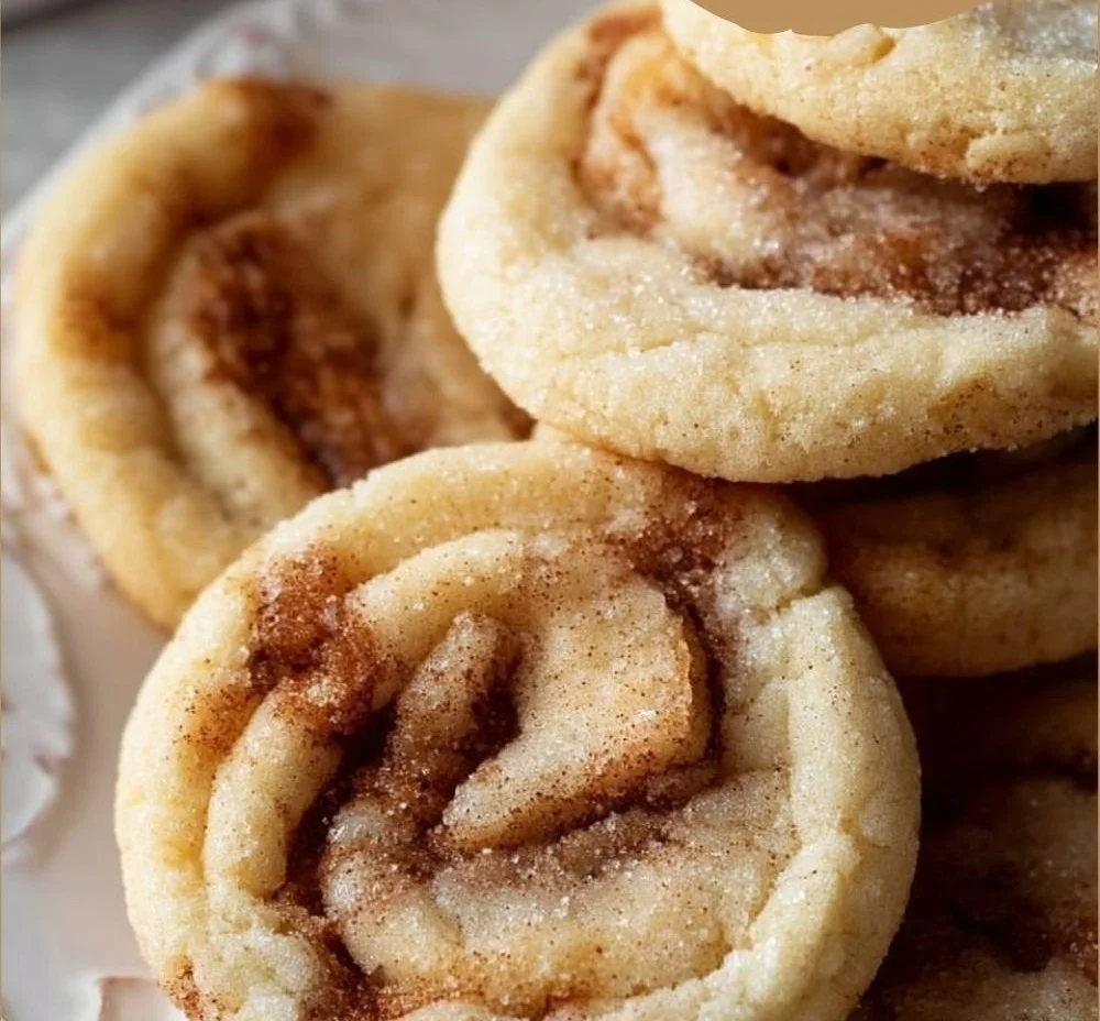 Soft and chewy cinnamon roll cookies with icing on a plate
