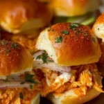 Spicy Buffalo chicken sliders served on a platter with dipping sauce