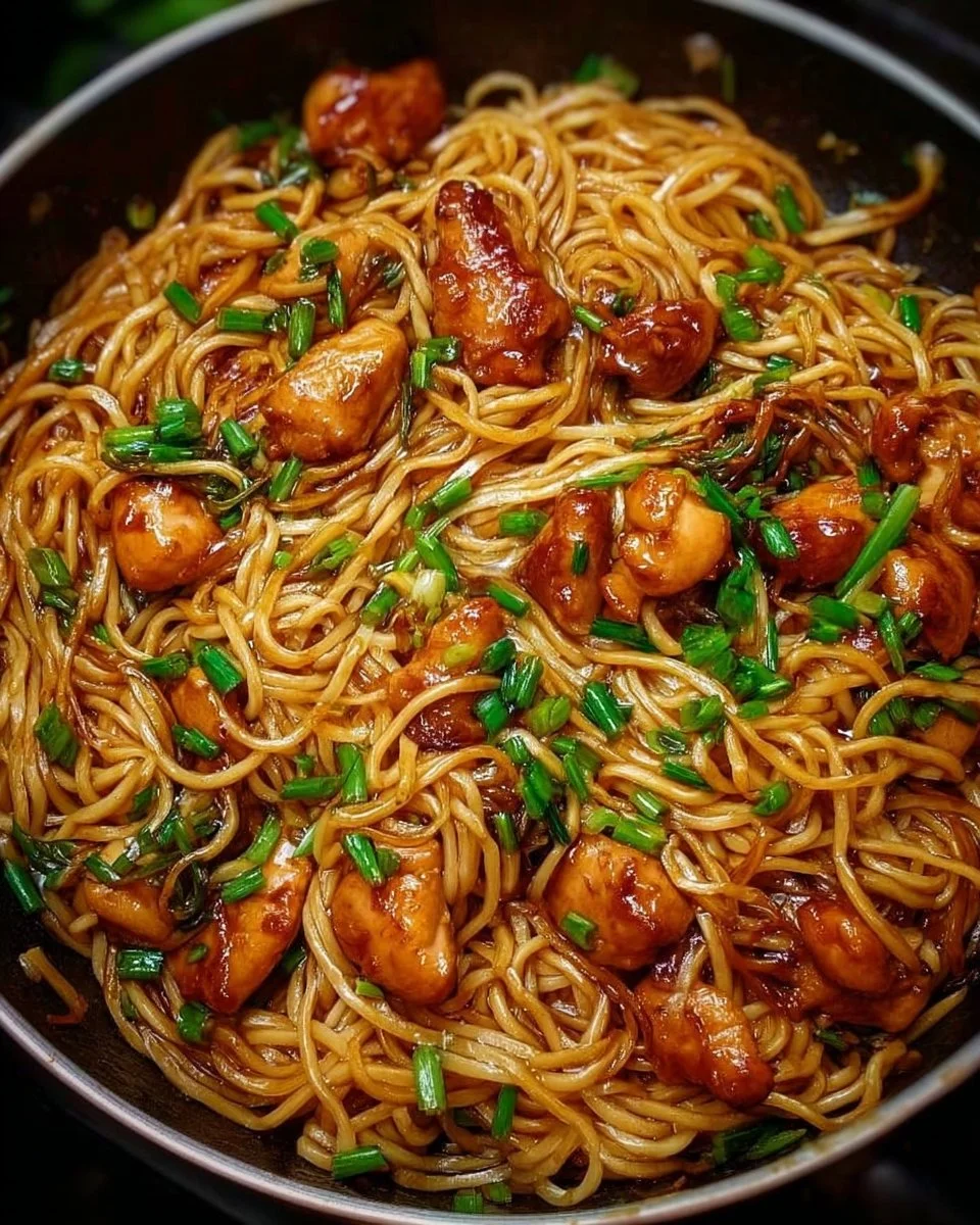 Delicious sticky garlic chicken noodles served in a bowl