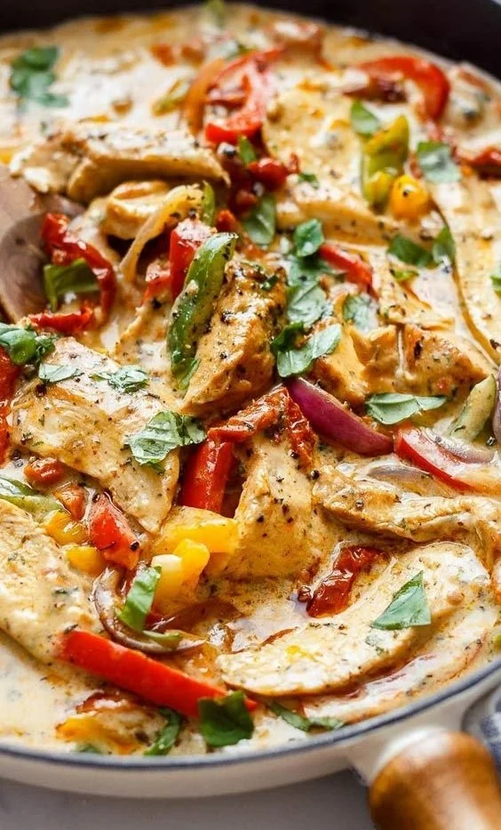 Creamy garlic pesto chicken served on a plate with herbs