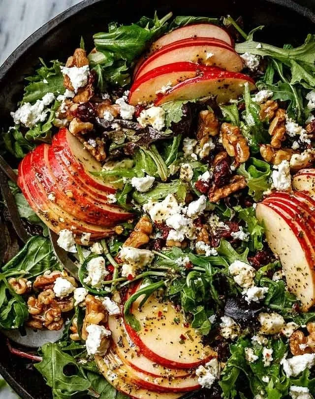 Colorful fall salad with roasted vegetables, nuts, and greens