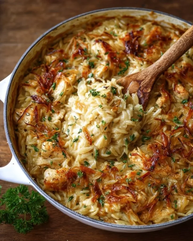 Delicious French onion chicken orzo casserole topped with cheese and herbs