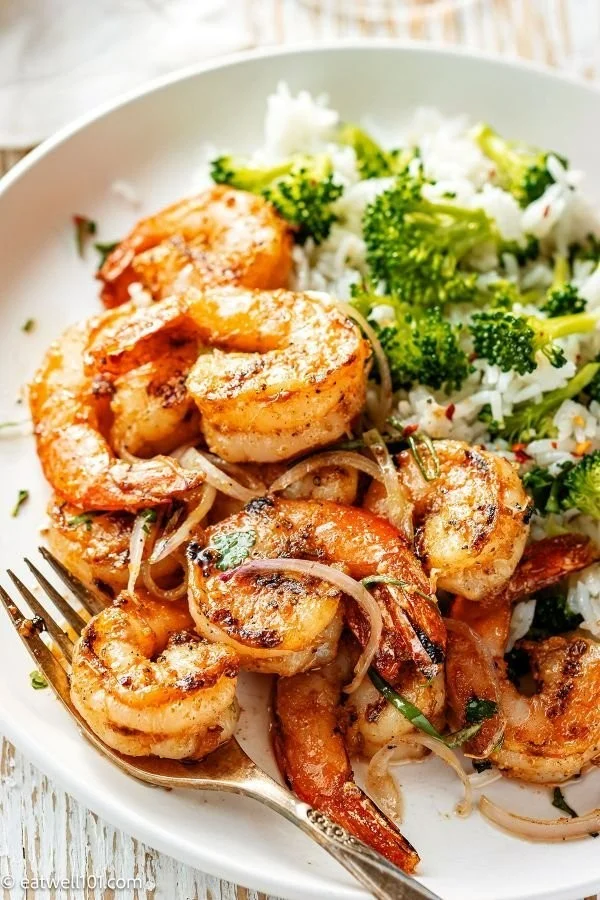 Garlic Butter Shrimp served with broccoli rice on a plate
