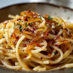 Delicious caramelized onion pasta drizzled with chili oil for added flavor