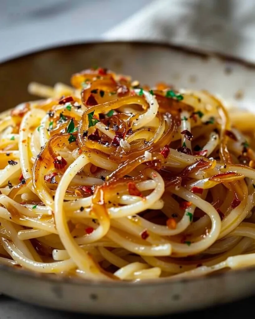 Delicious caramelized onion pasta drizzled with chili oil for added flavor