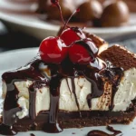 Delicious hot fudge sundae brownie cheesecake served with whipped cream and chocolate drizzle.