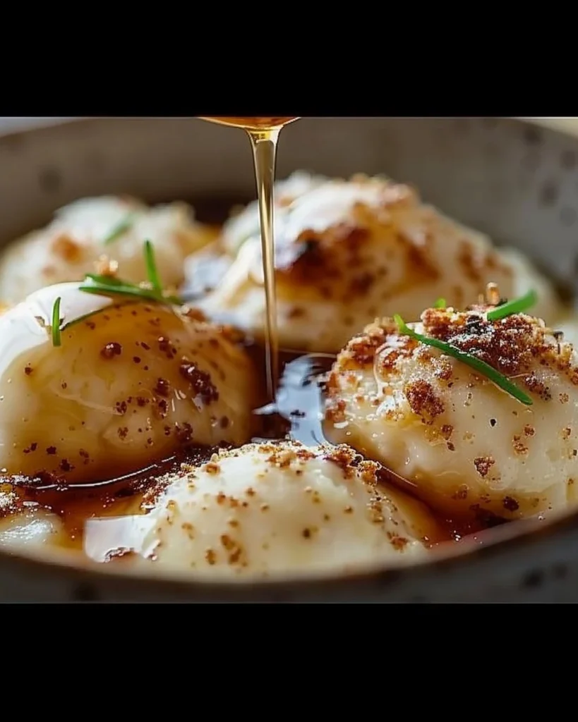 Parmesan–Asiago Cream with orange zest and white balsamic honey on a wooden board.