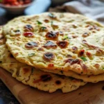 Homemade easy gluten-free flatbread on a rustic wooden table.