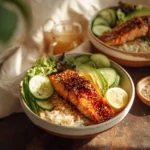Honey Glazed Salmon Bowl with vegetables and rice, drizzled with sauce