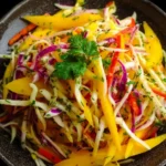 Colorful mango slaw with vibrant vegetables in a bowl